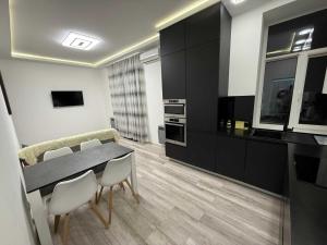 a kitchen with a table and chairs in a room at Chirons Rest in Volos