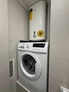 a washer and dryer with a box on top of it at Chirons Rest in Volos