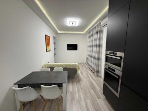 a kitchen and dining room with a table and chairs at Chirons Rest in Volos +4 photos