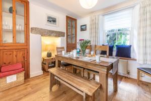 a dining room with a table and a bench at 3 Bed in Porthleven oc-harbli in Porthleven