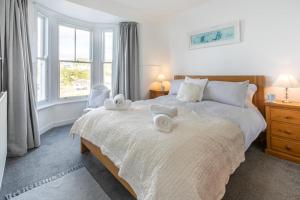 a bedroom with two beds with towels on them at 3 Bed in Porthleven oc-harbli in Porthleven
