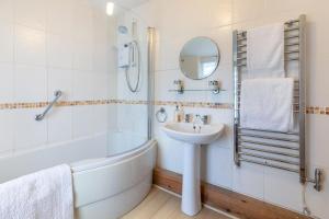a bathroom with a sink and a bath tub and a sink at 3 Bed in Porthleven oc-harbli in Porthleven +14 photos