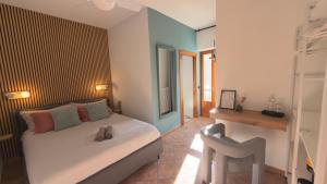 a bedroom with a bed and a chair in it at Casa Alba Blu in Dogliani +101 photos