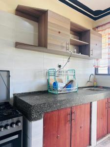 a kitchen with a counter with a basket on it at Honed homes in Mombasa