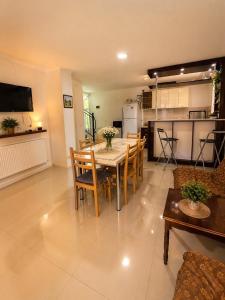 a dining room and kitchen with a table and chairs at cottage in tsemi (Borjomi) in Borjomi