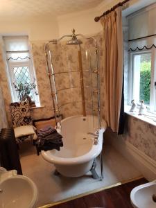 a bathroom with a large tub and a sink at Moon River in Goodwick +4 photos