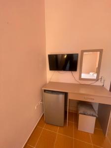 a desk with a computer on it with a mirror at Bleta Residence in Sarandë