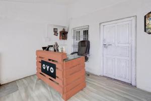a white room with a white door and a desk at hotel O snow breeze adventures in Dhanaulti