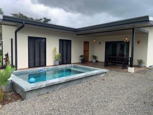 a swimming pool in the backyard of a house at Villa Shambala Arenal Volcano View Private Pool 6 Guests in Tanque