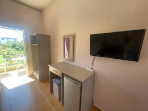 a room with a flat screen tv on the wall at Bleta Residence in Sarandë