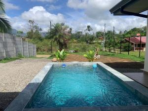 a swimming pool in the yard of a house at Villa Shambala Arenal Volcano View Private Pool 6 Guests in Tanque