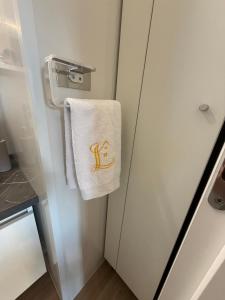 a towel hanging on a refrigerator in a kitchen at GoLD mobile homes D&L in Biograd na Moru +15 photos