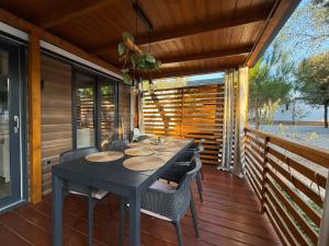 a table and chairs on the porch of a house at GoLD mobile homes D&L in Biograd na Moru