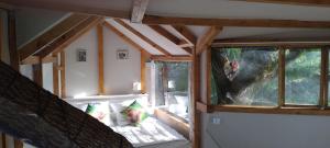 a room with a bed in a house with windows at B&B La Cabane Insolite in Monès