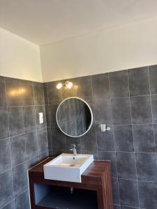a bathroom with a sink and a mirror at Chez Diarra in Saint-Louis +23 photos