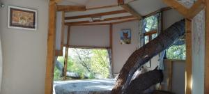 a room with a bed and a large window at B&B La Cabane Insolite in Monès