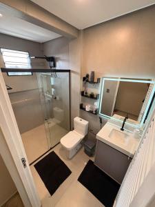 a bathroom with a shower and a toilet and a sink at Modern apartment, with excellent location in Macapá +40 photos