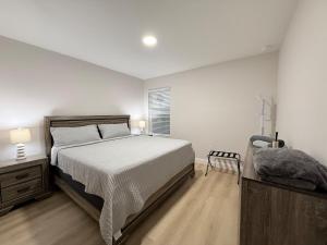 a bedroom with a large bed and a window at Chic 3BR, 2BA -Brand New! in Englewood