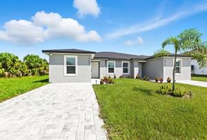 a house with a green lawn in front of it at Chic 3BR, 2BA -Brand New! in Englewood