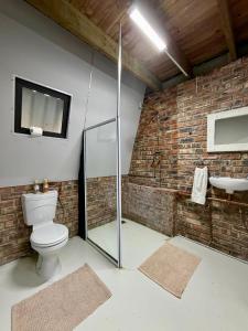 a bathroom with a shower and a toilet and a sink at Esperanza Dira's in George