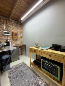a kitchen with a table and a counter in a room at Esperanza Dira's in George