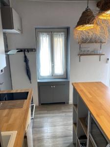 a kitchen with a window and a table in it at Cassis et ses trésors in Cassis +38 photos