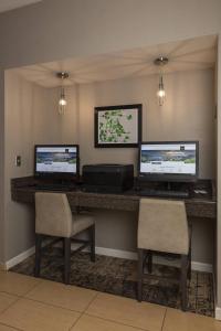 a lobby with three computer monitors and two chairs at Residence Inn by Marriott Durango Downtown in Durango