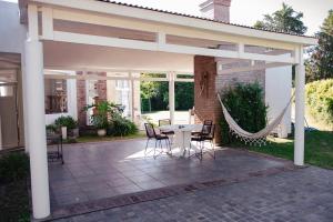 a pavilion with a table and chairs on a patio at AMADO-Un sueño in Junín