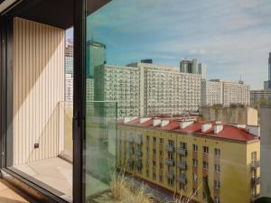a view of a city skyline from a window at Scarlet Jacuzzi Suit by Sofija in Warsaw