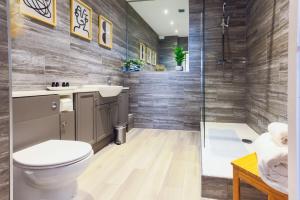 a bathroom with a toilet and a shower at Luxury 1BR Seafront Apartment in Cardiff +63 photos