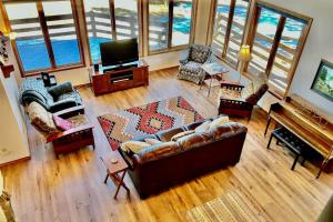 a living room with a couch and a television at Wren Ridge in Pagosa Springs