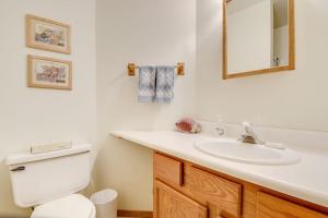 a bathroom with a toilet and a sink and a mirror at Wren Ridge in Pagosa Springs +38 photos