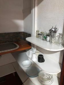 a bathroom with a white toilet and a shelf at Knowles Nook Self-catering in Klerksdorp +3 photos