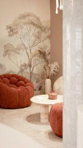 a room with a couch and a table and a tree mural at Hotel Donia Sfax in Sfax