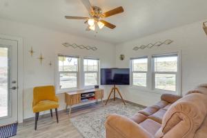 a living room with a couch and a ceiling fan at Route 66 Roadtripper Retreat w/ Private Backyard in Kingman