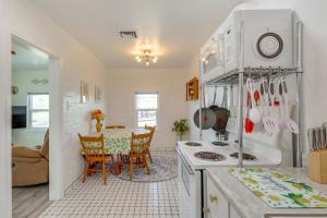a kitchen with a table and a dining room at Route 66 Roadtripper Retreat w/ Private Backyard in Kingman