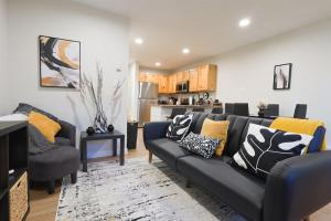 a living room with a couch and a kitchen at Luxuriously Contemporary Condo WL1401 Powder Mtn in Eden +50 photos