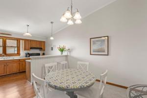 a kitchen and dining room with a table and chairs at Ocean Views From Every Room in Kitty Hawk