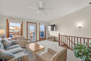 a living room with a couch and a table at Ocean Views From Every Room in Kitty Hawk