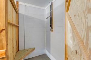 a bathroom with a shower with a bench in it at Ocean Views From Every Room in Kitty Hawk +47 photos