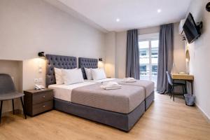 a bedroom with a large bed and a window at New Amaryllis Hotel in Athens