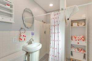 a bathroom with a sink and a shower curtain at Route 66 Roadtripper Retreat w/ Private Backyard in Kingman +17 photos