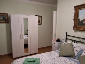 a bedroom with a white cabinet and a bed at Imperiale in Sarzana