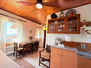 a kitchen and dining room with a dining table at Camarina Sea View in Kamarína