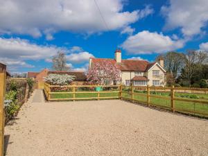 a fence in front of a house with a kite at The Old Piggery in Shifnal
