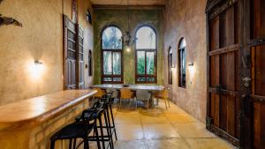 a large room with a table and chairs and windows at Zamas Hotel in Tulum