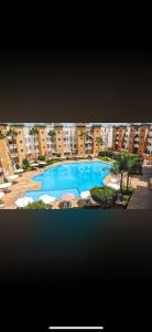 an overhead view of a large swimming pool with buildings at Résidence Al kawtar, Mimosa Appartement in Ben Slimane