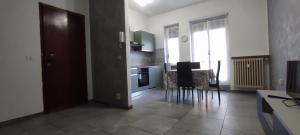 a kitchen with a table and chairs in a room at Alloggio Tommy in Biella
