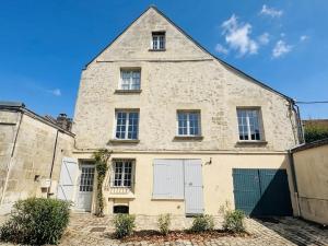 an old stone building with white doors and windows at Good vibes à Senlis in Senlis