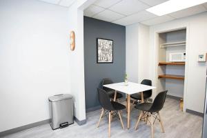 a dining room with a table and chairs at Wardens Quarters: 2 Bedroom Apt in Sault Ste. Marie